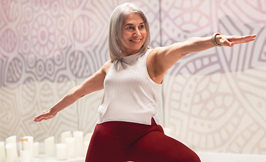 Woman and man do mountain pose on yoga mats