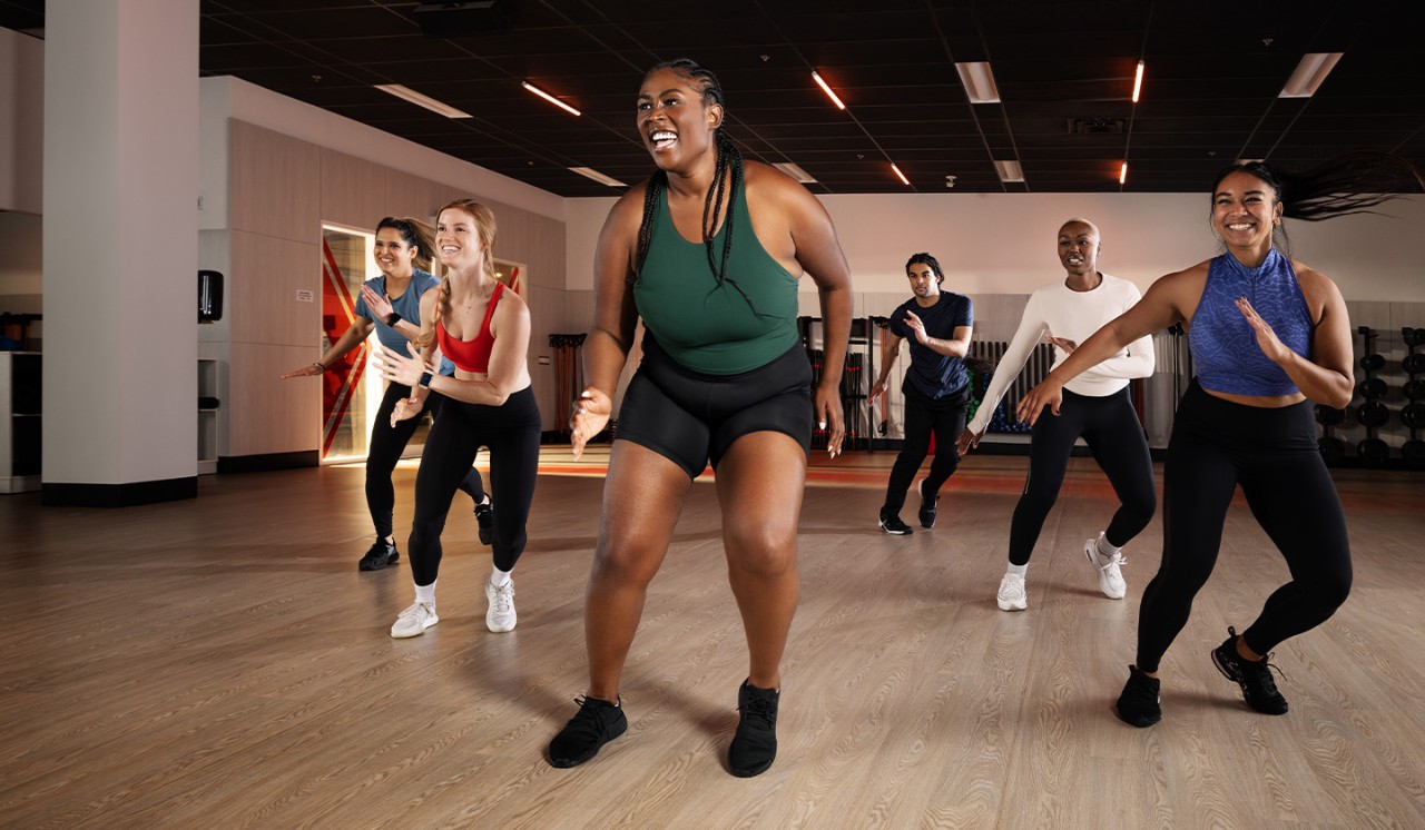 Woman looking forward while doing a plank on mat
