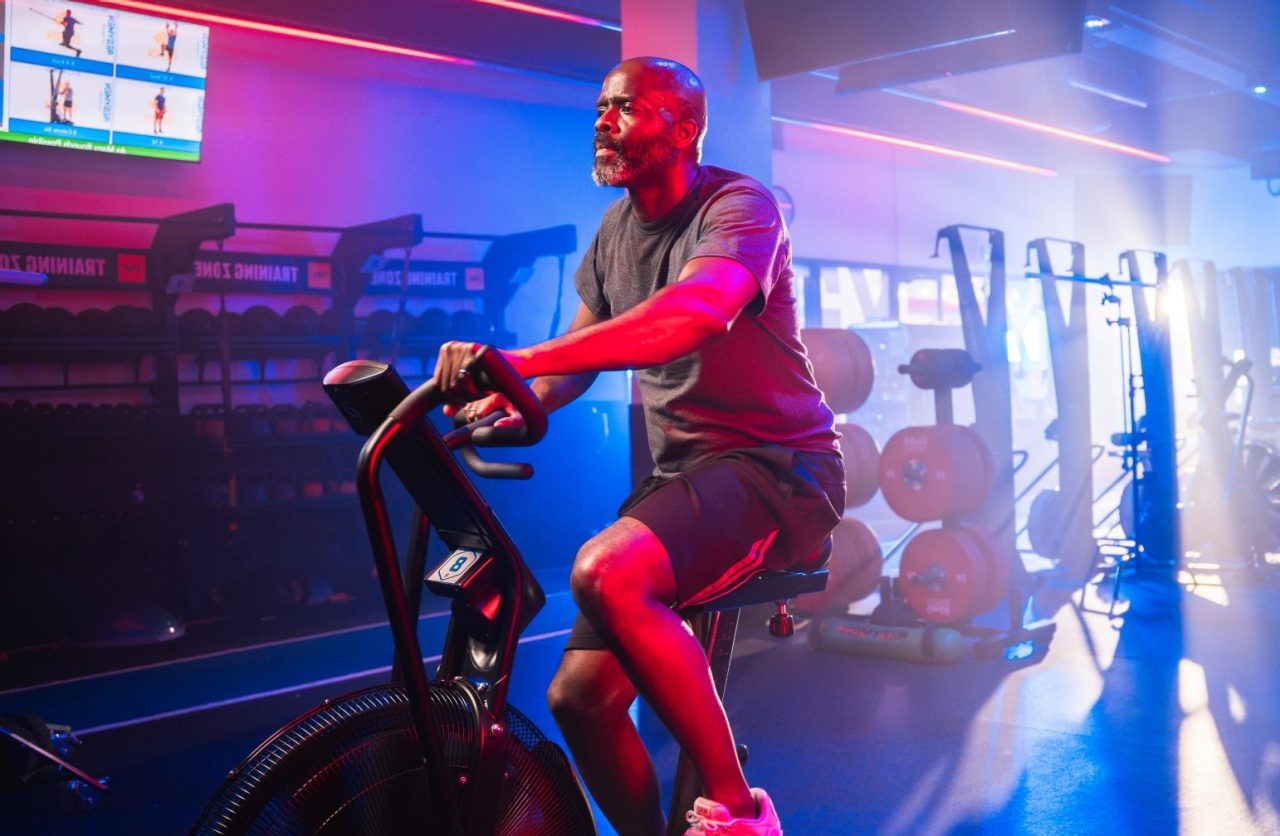Woman looking forward while doing a plank on mat