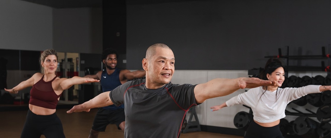 A group of GoodLife Fitness members stretch as a part of a Flexibility and Mobility class.